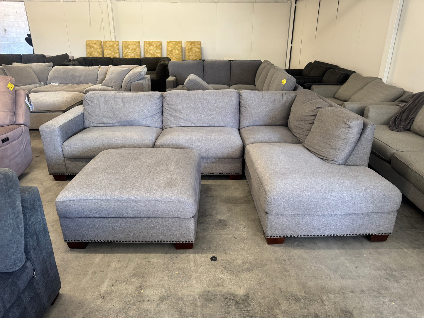 Gray L Shape Sofa with Ornate Trim and Ottoman