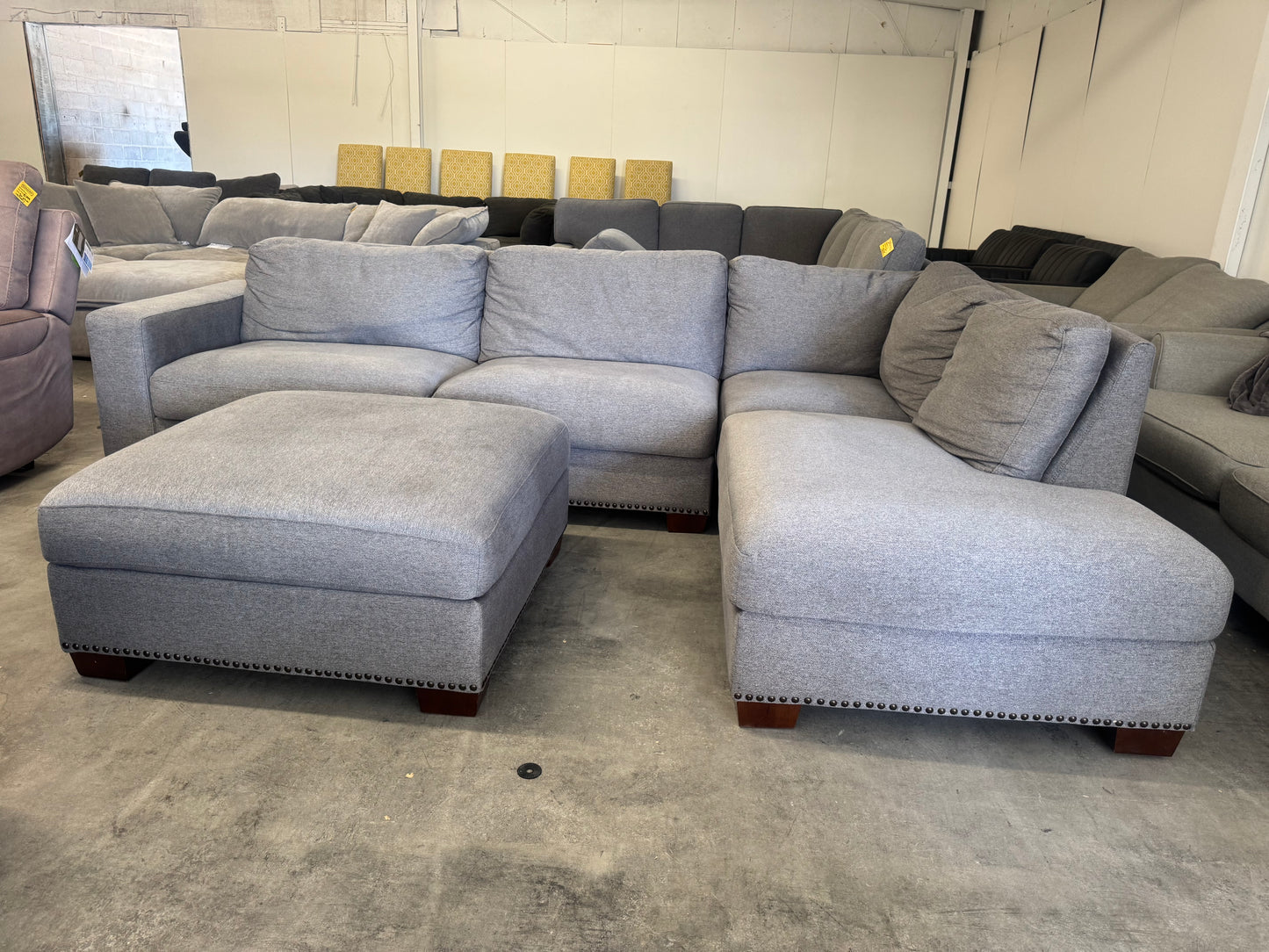 Gray L Shape Sofa with Ornate Trim and Ottoman