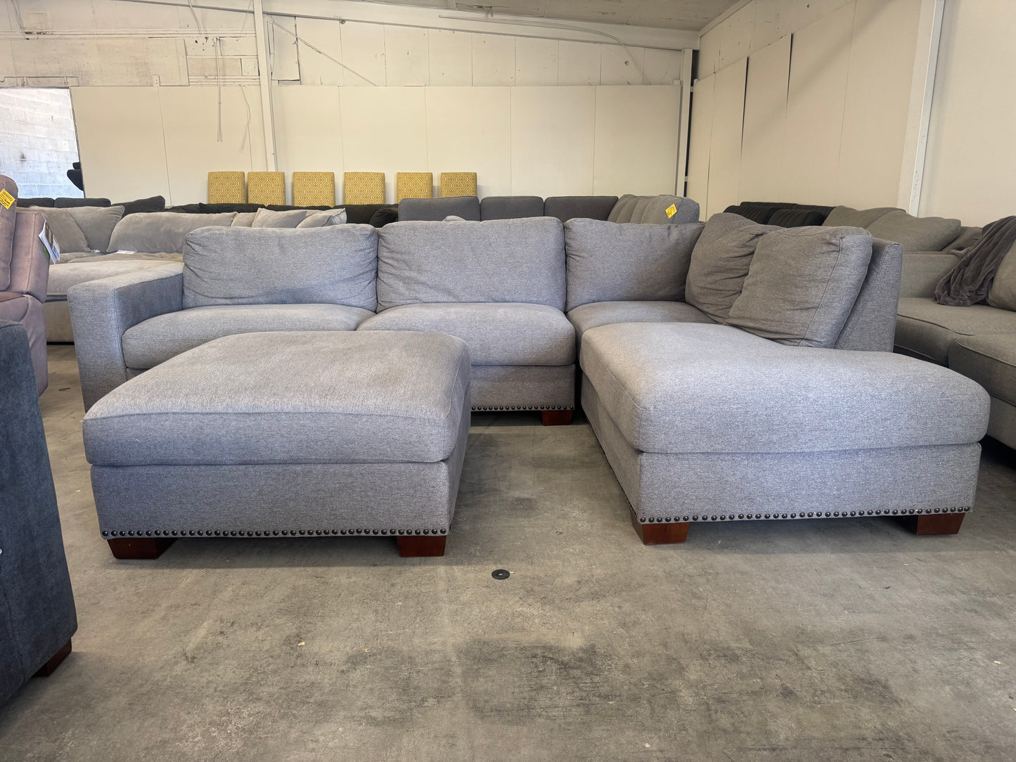 Gray L Shape Sofa with Ornate Trim and Ottoman