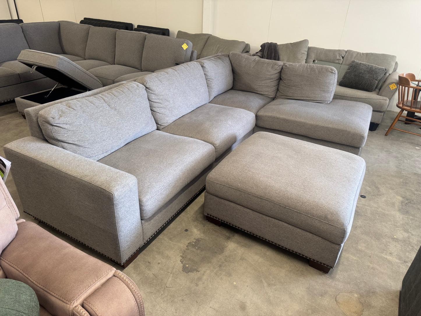 Gray L Shape Sofa with Ornate Trim and Ottoman
