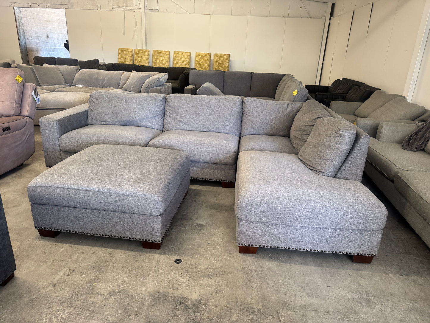 Gray L Shape Sofa with Ornate Trim and Ottoman